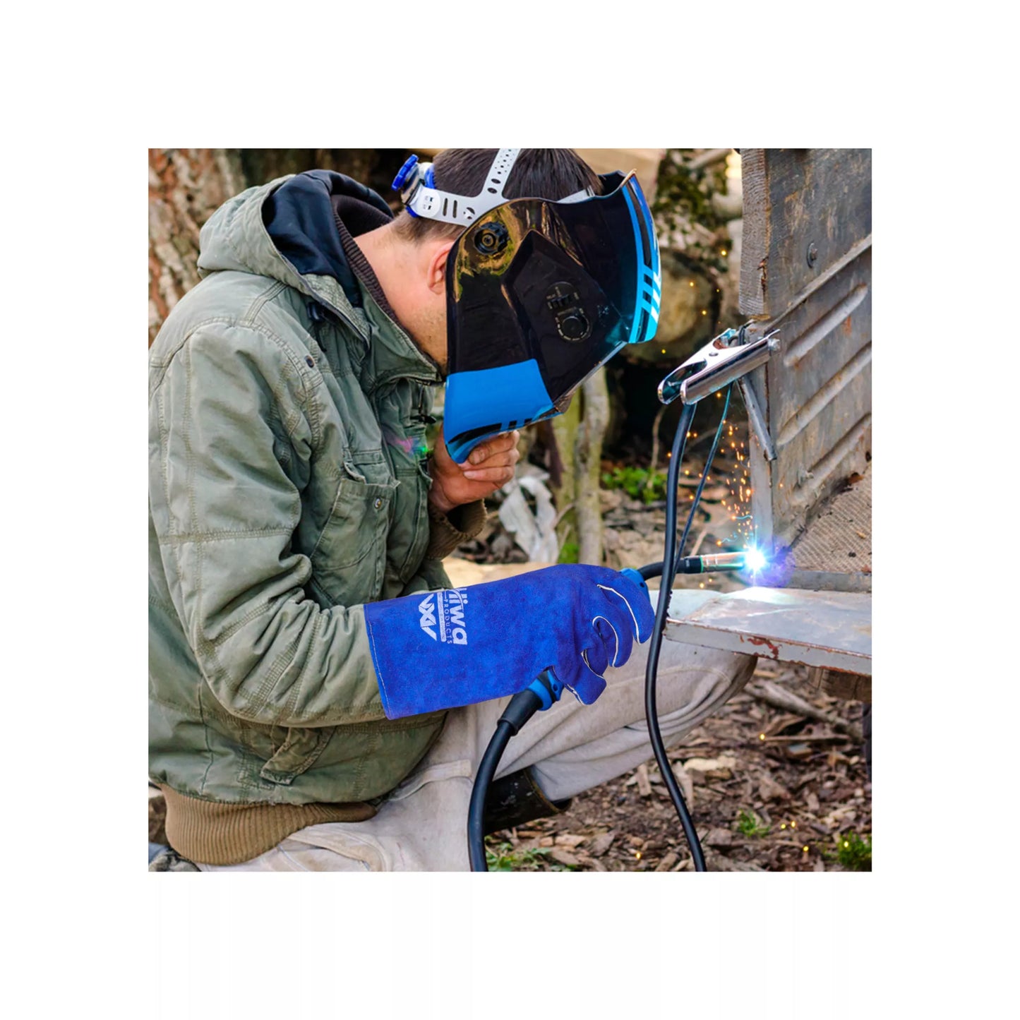 Worker wearing blue cowhide leather gloves while welding metal with heat and spark protection