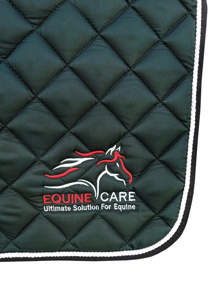 Close-up of Equine Care logo embroidery on bottle green quilted English saddle pad