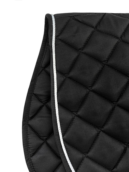 Close-up of black Equine Care quilted saddle pad showing padded core and durable binding