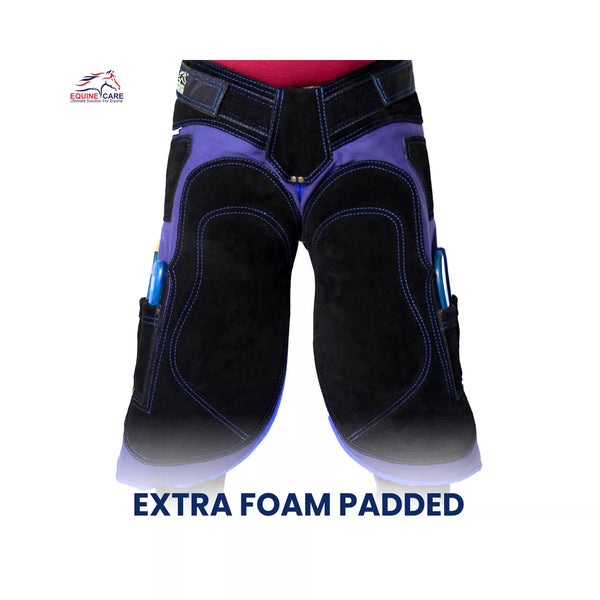 Front view of black and blue extra foam padded farrier chaps with reinforced thigh panels and side tool pockets, designed for professional horse shoeing and hoof care work